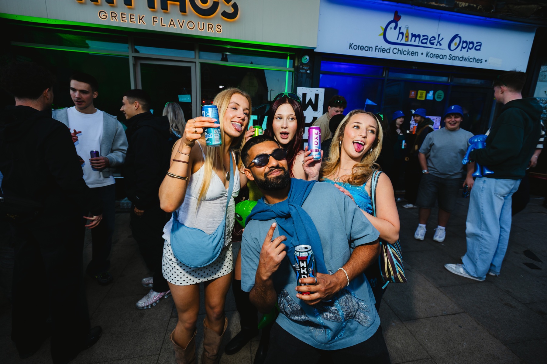 A group of people celebrating at a WKD activation